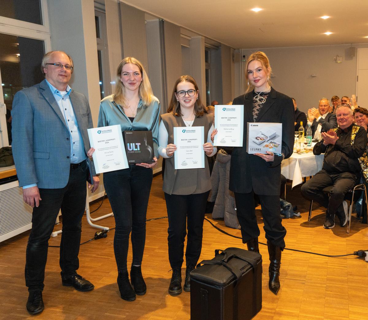 Die Preisträgerinnen Sarah Zeh (1. Preis), Alicia Solle (2. Preis) und Katharina Burg (3. Preis) gemeinsam mit dem Bundesinnungsmeister Henning Arndt bei der Preisverleihung (Foto: Luisa Kaiser)